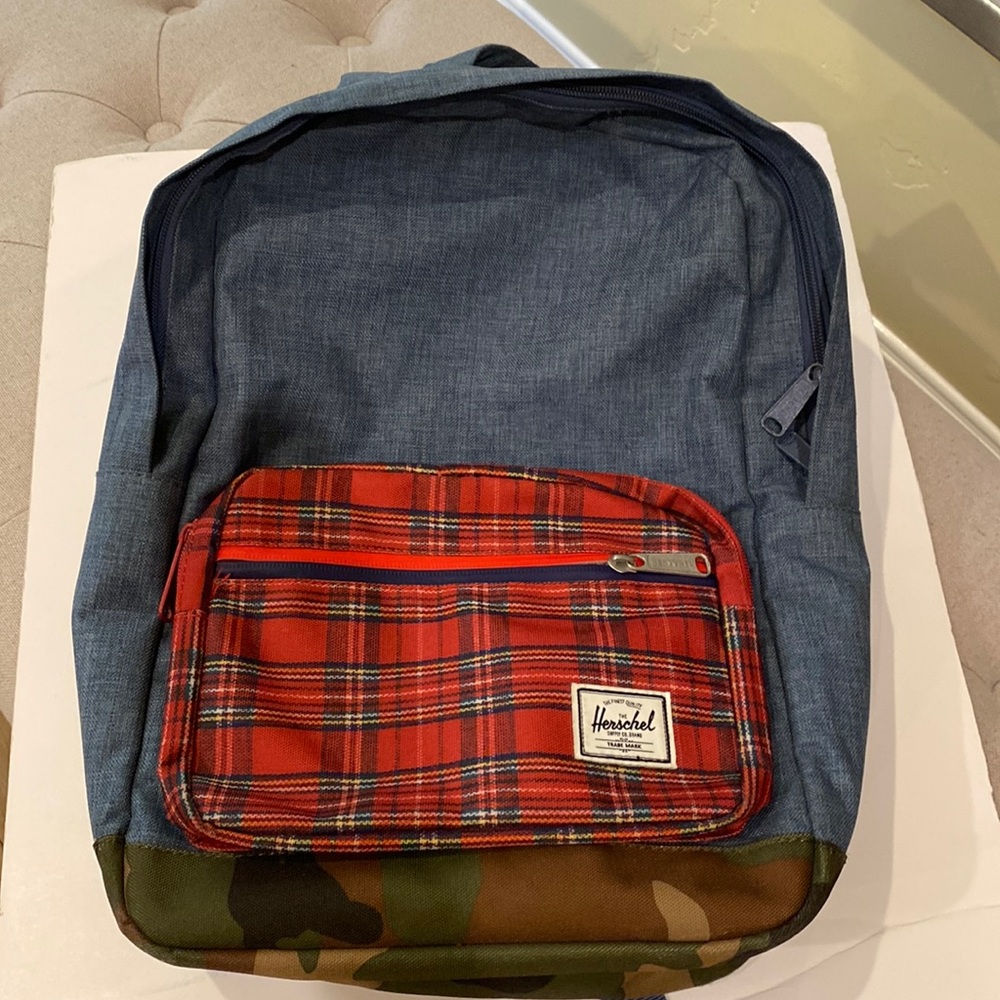 Herschel denim backpack with plaid pocket, & camo bottom. Used once.